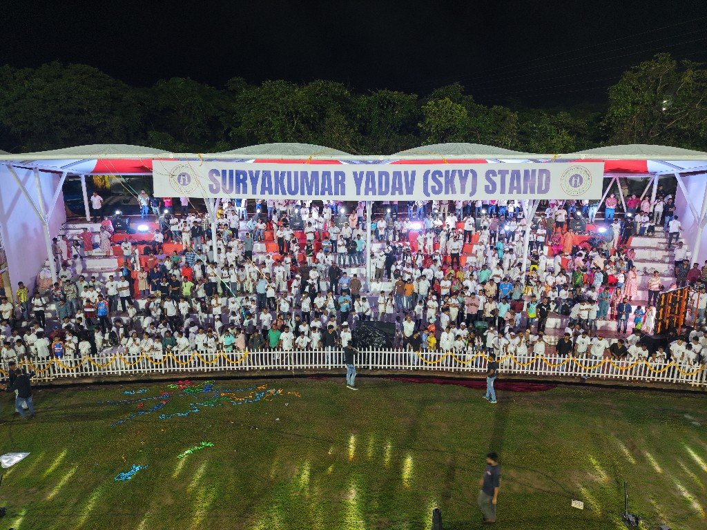 Night drone view of 1919 Sportz stadium with floodlights and stands