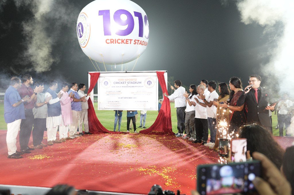 Official guests on red carpet stage at 1919 Sportz Cricket Stadium
